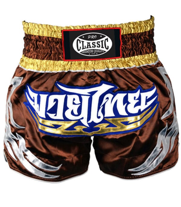Muay Thai shorts in custom brown and yellow design with logo placement, ideal for private label and OEM manufacturing.